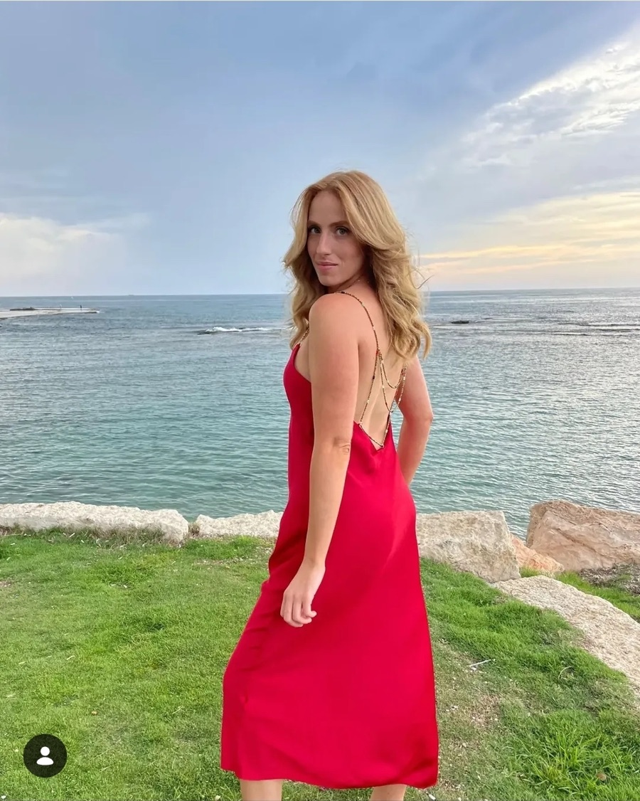Red dress overlooking the sea