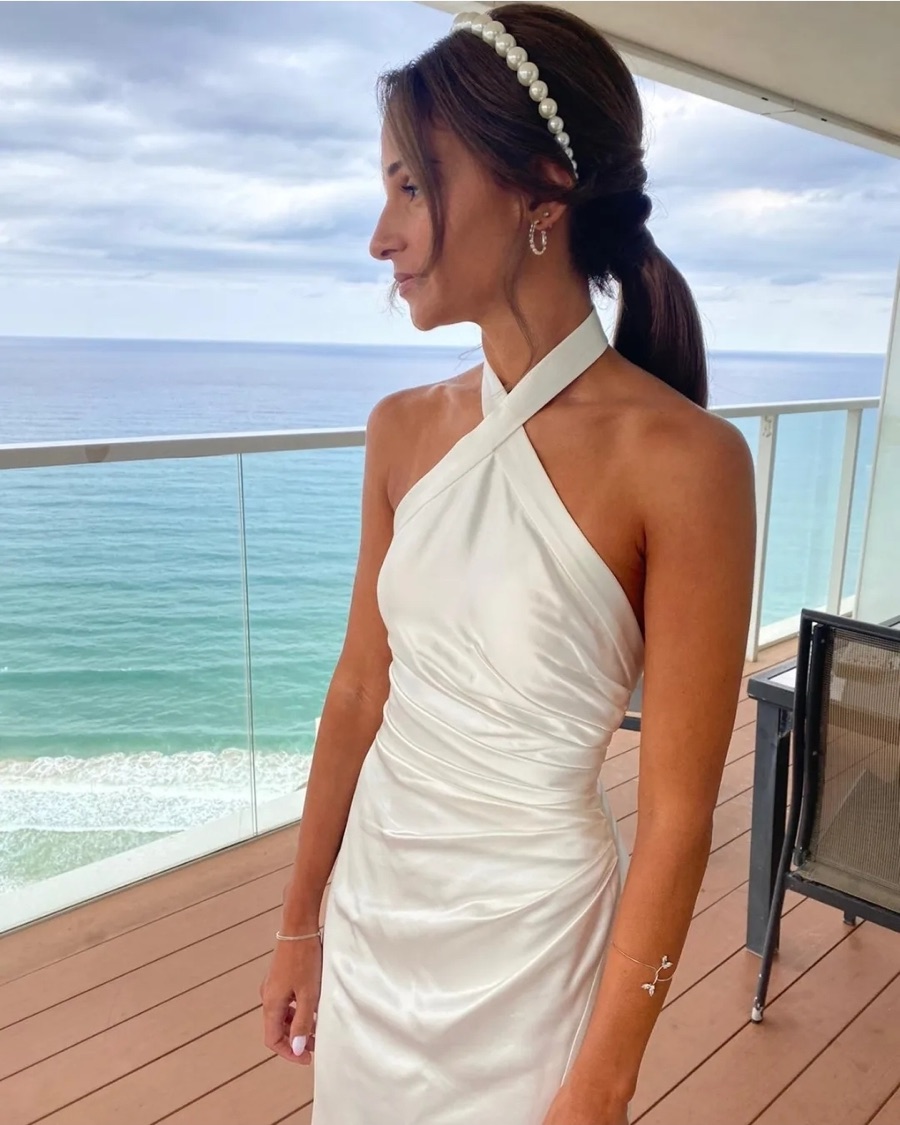 White halter dress on a balcony overlooking the sea